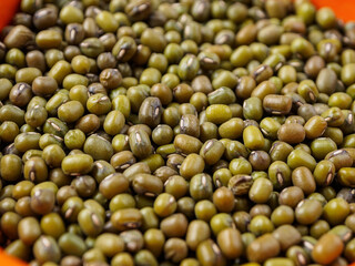 Mung beans on a light background, emphasizing their shape and texture, create a feeling of freshness and naturalness.