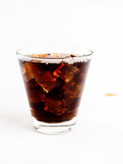 Pouring Cola with Ice in Glass on White Background