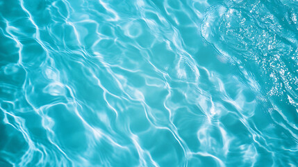 Fototapeta premium Clear turquoise water surface with light reflections and ripple patterns. Top view. Summer vacation and tropical relaxation concept. Design for wallpaper, banner, header.