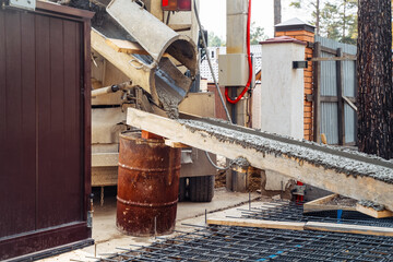 Pouring ready mixed concrete after placing steel reinforcement.