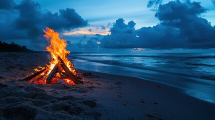 A bonfire on the beach with people enjoying music and conversation.