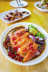 Fresh salmon spicy salad with spicy sauce, Thai spicy food