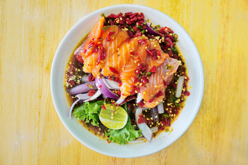 Fresh salmon spicy salad with spicy sauce, Thai spicy food