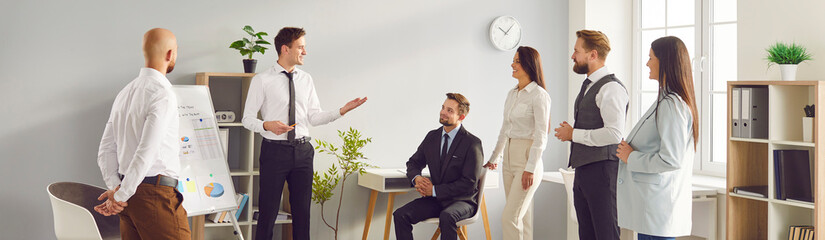 Group of colleagues on presentation or meeting in office. Engaged in work, demonstrating teamwork...