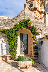 Group of beautiful Trulli, traditional Apulian dry stone hut old houses with a conical roof in Itria Valley, Puglia, Italy
