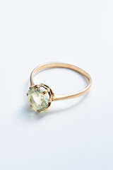 Elegant Gold Ring with Green Gemstone on White Background