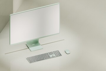 Mockup green desktop computer on light green tile floor. White blank screen for template material.