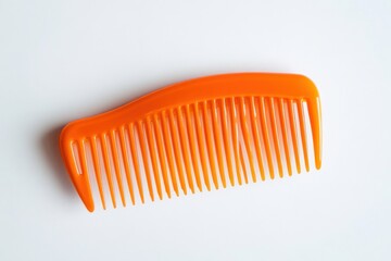 Bright orange plastic comb resting on a smooth white surface during early morning light isolated on transparent background