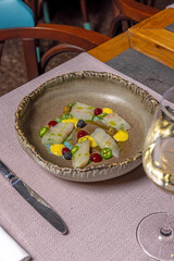 Raw white fish with jalapeño peppers served in a restaurant