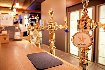 Golden Beer Taps at a Sapporo Brewery Bar