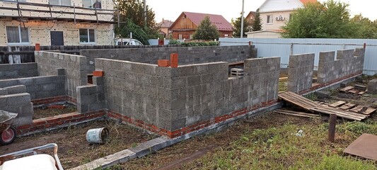 Fototapeta premium unfinished block walls standing on a brick foundation