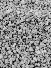 Crushed metallurgical slag. Fine fraction. Porous structure. Production waste. Recycling, reuse. Use for road construction. Gray background. Black and white photo. Copy space for text.