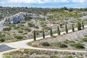 landscape with a asphalt road between rocky slopes on the Istrian Peninsula, Croatia 
