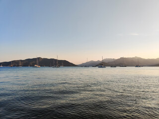 beautiful ships and boats are moored near the shore