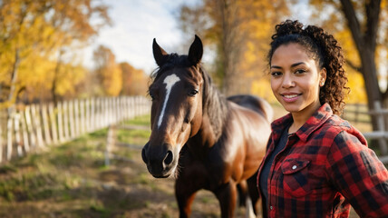 Fototapeta premium Woman standing next to horse at the horse stud in countryside. Equestarian and horseback riding hobby. Woman horse rider