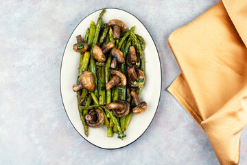 Baked asparagus spears with mushrooms.