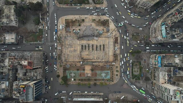 Aerial view of a public square in Aleppo showing a parade of Syrian security forces
