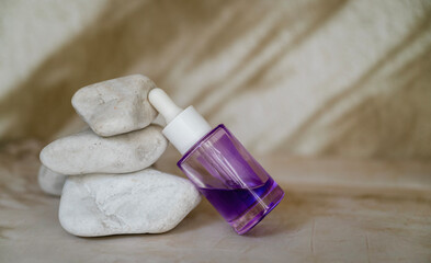 Bakuchiol face serum in a glass bottle on shadows background 