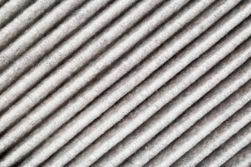 Background of modern carbon filter for air purification in car interior, close-up