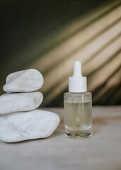Anti-Age Eye Face Serum in Glass Bottle on a shadows background 
