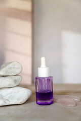 Bakuchiol face serum in a glass bottle on shadows background 