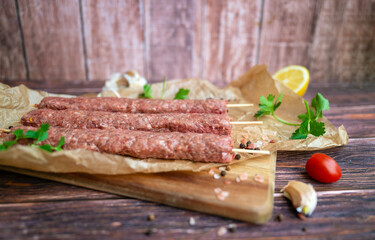 Raw Turkish adana shish kebab skewers