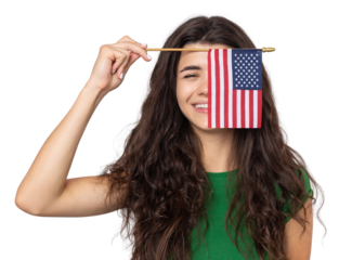 A young happy girl with a smile on her face holds an American flag in her hands. Symbol of patriotism and freedom.