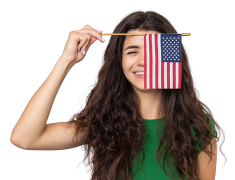 A young happy girl with a smile on her face holds an American flag in her hands. Symbol of patriotism and freedom.