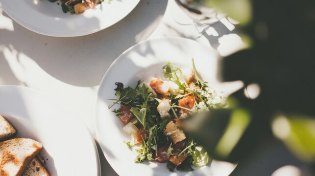 Vibrant summer panzanella salad featuring grilled vegetable tops, wilted greens, and stale bread with compost ready scraps set aside