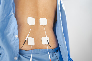 image shows person receiving electrical stimulation therapy for physical rehabilitation. This method aids in recovery and pain relief