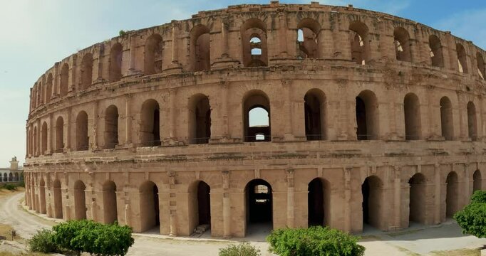 Exteriof facade arches of historic Roman Amphitheatre in El Jem, Tunisia Under Bright Sunshine