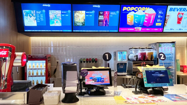 Jakarta, Indonesia - March 08, 2025:  Interior atmosphere of the Cinepolis cinema in Jakarta. Concession or snack stand where people buy popcorn and soda