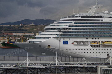Modern cruiseship cruise ship liner Favolosa docked in Marseille Provence, France with coast line, city skyline and beautiful nature landscape scenery during Mediterranean summer cruising