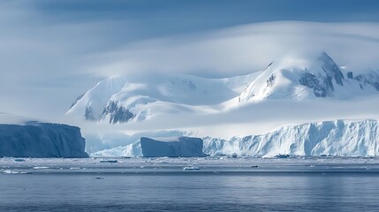 Snowy Mountain Landscape with Icebergs in Antarctica Ocean on Cloudy Day