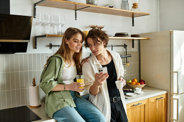 Young couple enjoying a cozy morning in their modern kitchen while sharing joyful moments