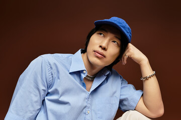 Stylish young man poses thoughtfully in an artistic studio setting