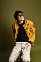 Stylish young man showcases trendy fashion in modern studio setting