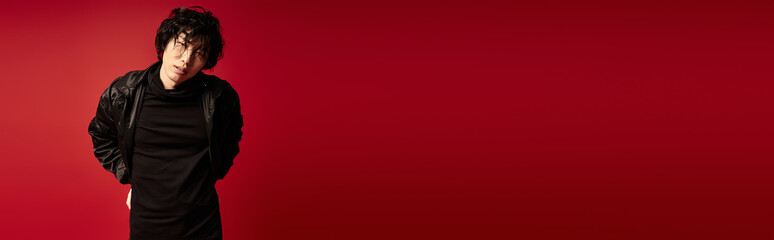 Fototapeta premium Crimson confidence a stylish asian man poses fashionably in studio