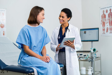 Female doctor consulting young caucasian female patient in medical office
