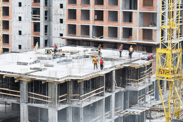 Construction site background. Hoisting cranes and new multi-storey buildings. Industrial background.