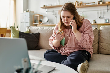 Young woman with Down syndrome enjoys a cozy moment at home while making a phone call