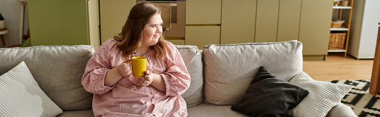 Comfort and joy in a cozy home with a confident young woman enjoying a warm drink