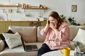 Young woman at home joyfully connecting with friends through a phone call while relaxed