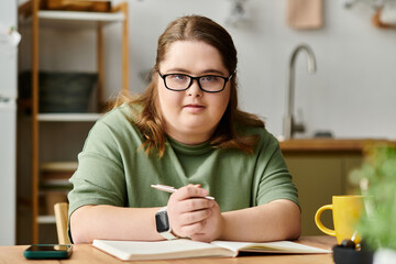 Young woman with Down syndrome embraces confidence in a cozy home setting while writing