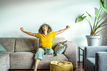 Happy afro american woman relaxing on the sofa at home