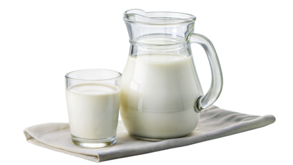 jug of milk and glass of milk on a piece of cloth