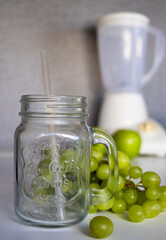 Glass cup and fresh fruits to prepare a green juice in a modern mimal kitchen.Antioxidant green fruit and vegetable shake .Vegetarian food ingredients.Healthy food concept