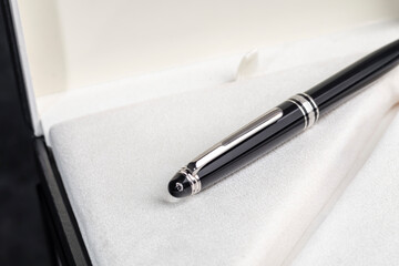 Fountain pen on marble and grey background. Selective focus.