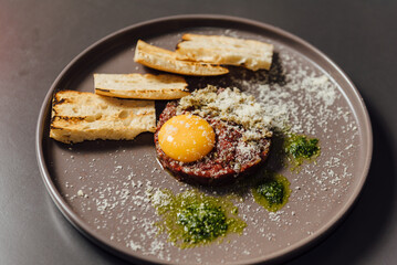Ostrich tartare with a rich Italian touch. Finely chopped ostrich meat served with egg yolk, capers, artichokes, cornichons, and Mars onion. Paired perfectly with signature toasted bread