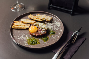 Ostrich tartare with a rich Italian touch. Finely chopped ostrich meat served with egg yolk, capers, artichokes, cornichons, and Mars onion. Paired perfectly with signature toasted bread